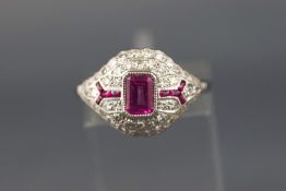 A white metal dress ring set with a rectangular cut pink sapphire of approximately 0.60 carats.