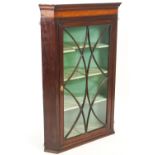 A George III mahogany corner cabinet,