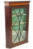 A George III mahogany corner cabinet,