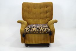 A Parker Knoll recliner chair, upholstered in gold corded fabric with a deep buttoned back,