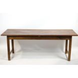A plain elm refectory table raised on plain square legs with end stretchers,