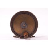 A brass composite fishing reel, stamp marked 'The Fly Fisher's' S E J Winch Regr,