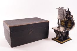 A cased Dorman Lockstitch miniature sewing machine