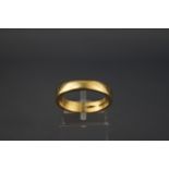 A yellow metal flat profile wedding ring. Hallmarked 18ct gold, London. Size P