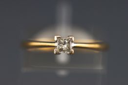 A yellow metal single stone ring set with a princess cut diamond, stated to weight 0.20 carats.