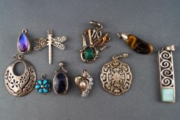 A collection of ten silver pendants of variable designs. Marked or tested as Sterling silver 925.