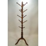 A turned hardwood hat and coat stand,