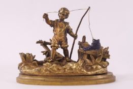A 19th century Ormulu "go to bed" taper stick, modelled with a boy fishing and catching a boot,