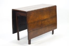 A plain rectangular elm wood gateleg table,