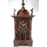 A 19th century hardwood and pine Black Forest combination strike and bellows clock,