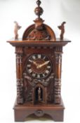 A 19th century hardwood and pine Black Forest combination strike and bellows clock,