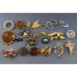 A collection of twenty costume brooches of various designs, all finished in base metal.