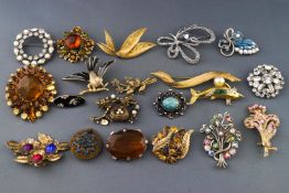 A collection of twenty costume brooches of various designs, all finished in base metal.