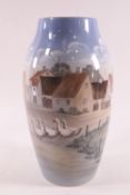 A Bing and Grondahl tall cylinder vase, decorated with a Danish village scene, No 551-6243,