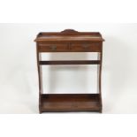 An Edwardian mahogany side table of rectangular form, the plain top with a shaped cornice,