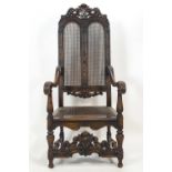 A carved hard wood elbow chair in the style of Daniel Marot,