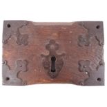 An 18th century iron and oak mounted door lock,