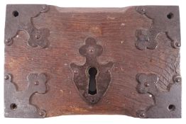 An 18th century iron and oak mounted door lock,