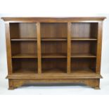 An oak open bookcase of large proportions with an edged plain rectangular top