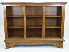 An oak open bookcase of large proportions with an edged plain rectangular top