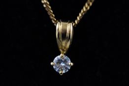 A yellow metal single stone pendant, set with a round brilliant cut diamond