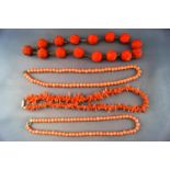 A collection of coral necklaces to include a large carved beaded necklace,