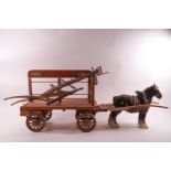 A miniature coal cart, a hay cart and a plough together with a Beswick shire horse,