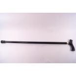 An ebonised walking stick with white metal collar,
