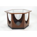 A G plan teak hexagonal coffee table, the top inset with a shaped glass panel,