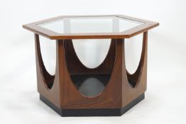 A G plan teak hexagonal coffee table, the top inset with a shaped glass panel,