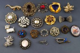 A collection of twenty one costume brooches of various designs, all finished in base metal.