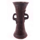 An art nouveau style pottery vase by Bretby with two ring handles, impressed marks,