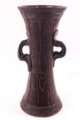 An art nouveau style pottery vase by Bretby with two ring handles, impressed marks,