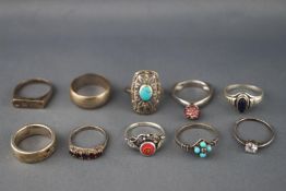 A collection of ten white metal rings of variable designs.