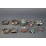 A collection of ten white metal rings of variable designs.