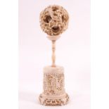 A late 19th century ivory concentric ball, on stand, overall 15.