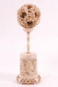 A late 19th century ivory concentric ball, on stand, overall 15.