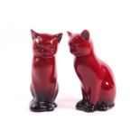 Two Royal Doulton flambe figures of seated cats,