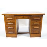 An oak twin pedestal desk with a plain rectangular top over a central drawer,