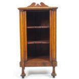 A mahogany music cabinet with a shaped cresting rail over a plain rectangular top