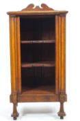 A mahogany music cabinet with a shaped cresting rail over a plain rectangular top