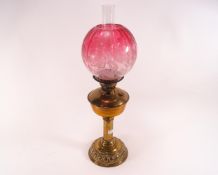 A Victorian oil lamp with etched cranberry tinted shade, on brass stand, 62.