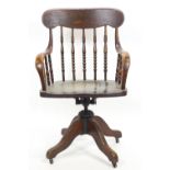 An elm and oak swivelling desk/office stick back swivel chair of traditional form