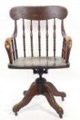 An elm and oak swivelling desk/office stick back swivel chair of traditional form