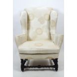 A William and Mary style wing back armchair