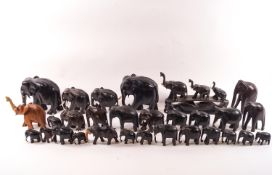 A collection of late 19th century/early 20th century carved hardwood elephants