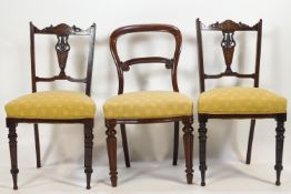 A pair of Edwardian mahogany salon chairs with carved cresting rails inlaid with Arabesques