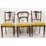 A pair of Edwardian mahogany salon chairs with carved cresting rails inlaid with Arabesques