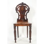 A mid 19th century mahogany hall chair,