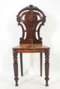 A mid 19th century mahogany hall chair,